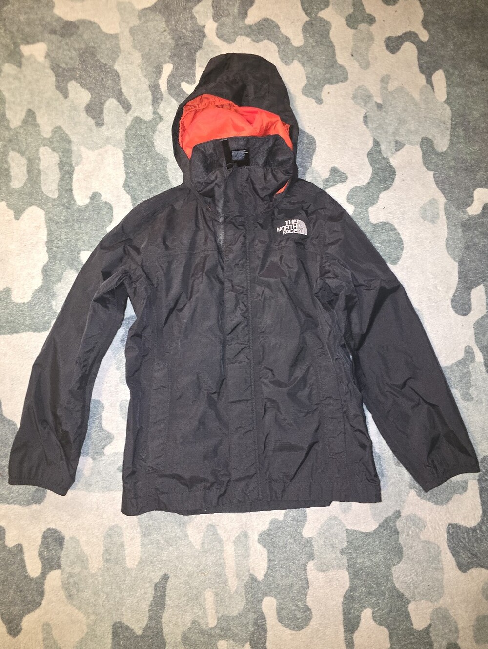 The North Face Black Raincoat with Red Hood Lining